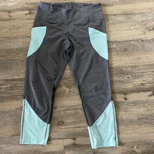 Grey heathered colorblocked cropped leggings with mesh cutouts